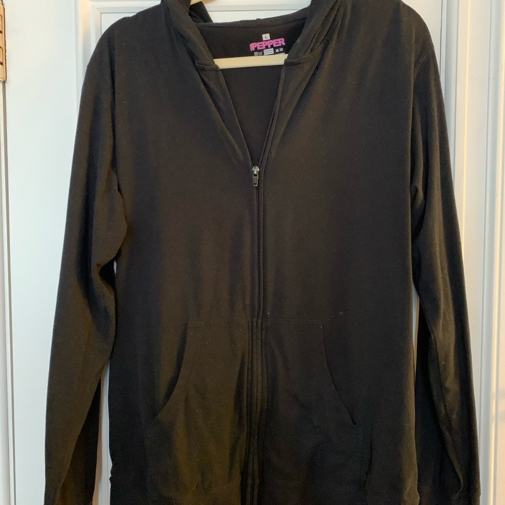Drain holding black hoodie by pink pepper